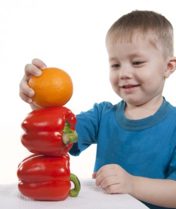 Vegetables and fruit it are a healthy food of children. Child holds different vegetables and fruit. Vegetables and fruit it are a healthy food of children. Child holds different vegetables and fruit.